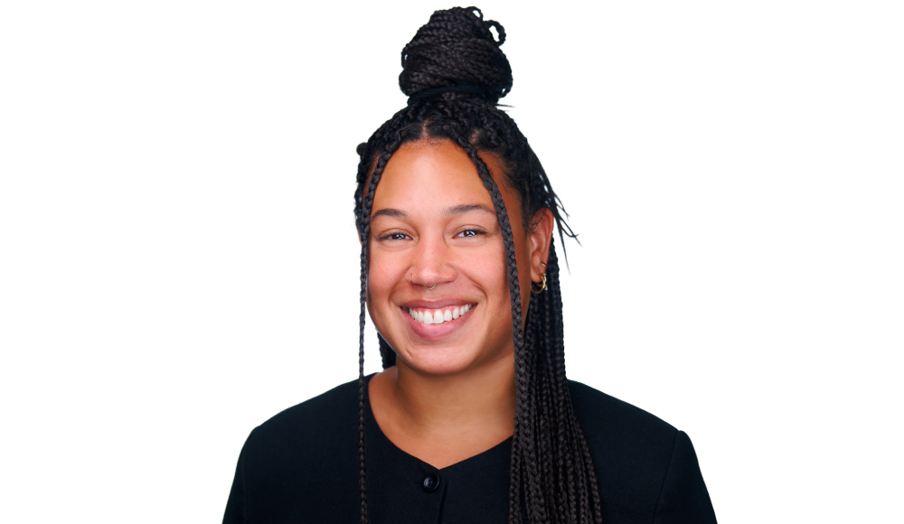 Headshot of Raven Milam smiling with a white background behind her.